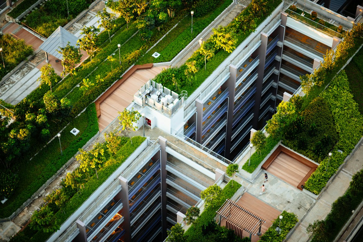 Modern building with extensive green roof terraces and landscaped gardens.