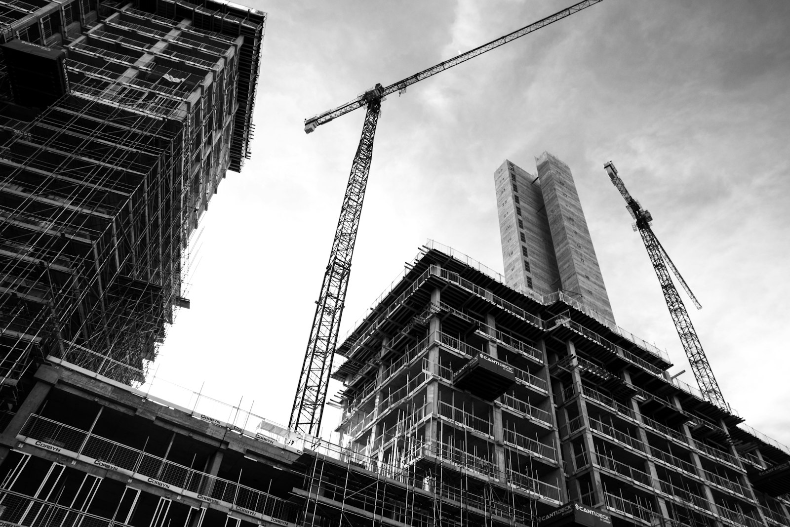 High-rise construction site with tower cranes and scaffolding